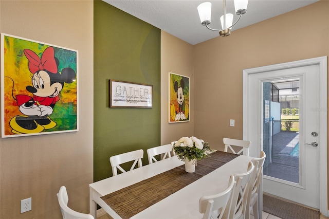 dining room featuring a notable chandelier and tile patterned floors