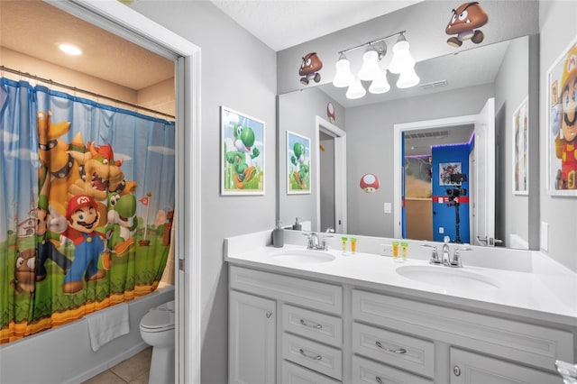 full bathroom featuring toilet, tile patterned floors, vanity, and shower / bath combo