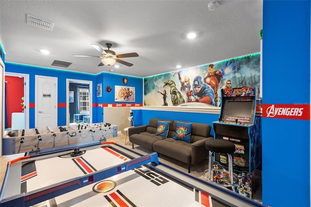 playroom with a textured ceiling and ceiling fan