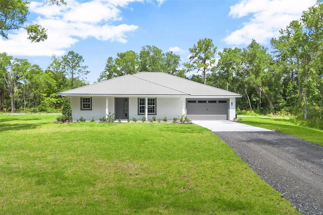 single story home with a garage, a front yard, metal roof, and driveway