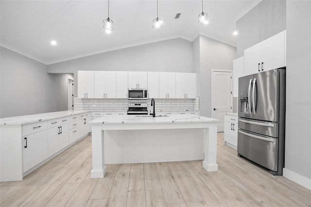 kitchen featuring stainless steel appliances, white cabinetry, a sink, and a peninsula