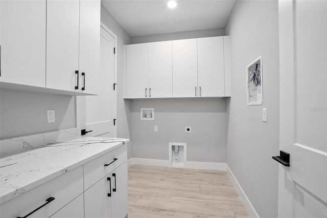 laundry room with wood finish floors, hookup for a washing machine, cabinet space, electric dryer hookup, and baseboards