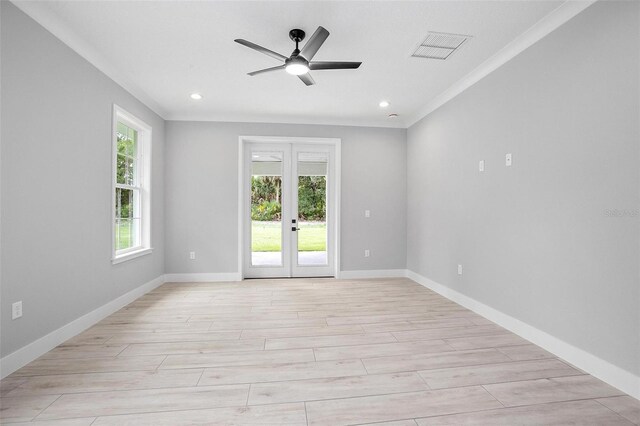 unfurnished room featuring light wood-style floors, french doors, visible vents, and baseboards