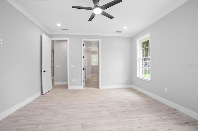 unfurnished bedroom featuring ornamental molding, light wood-type flooring, and visible vents