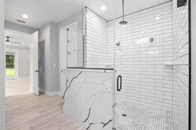 full bathroom with recessed lighting, wood finished floors, visible vents, baseboards, and a shower stall