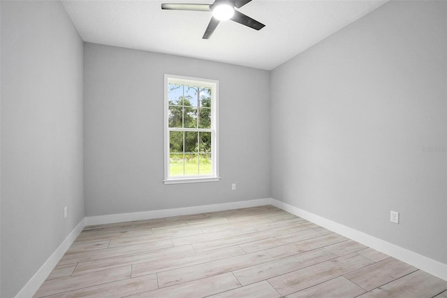 empty room with baseboards, light wood-style flooring, and a ceiling fan