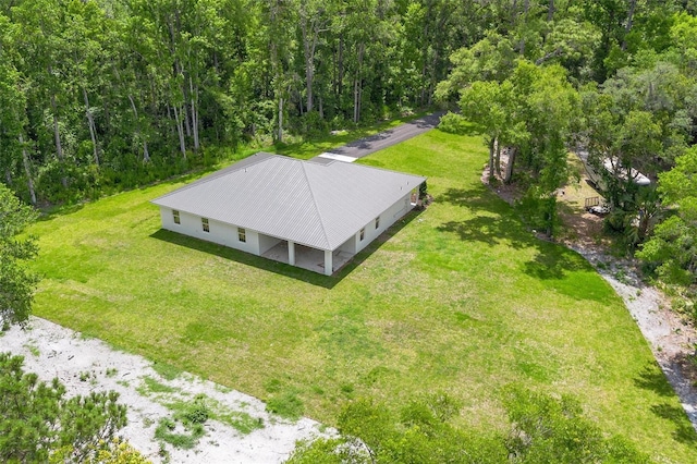 drone / aerial view featuring a view of trees