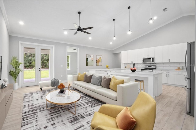 living area with high vaulted ceiling, french doors, crown molding, and light wood finished floors