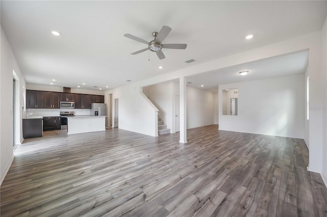 unfurnished living room featuring hardwood / wood-style flooring and ceiling fan