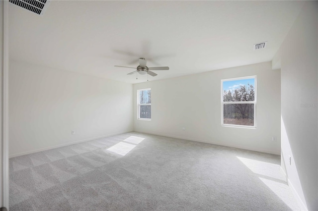 carpeted spare room with ceiling fan