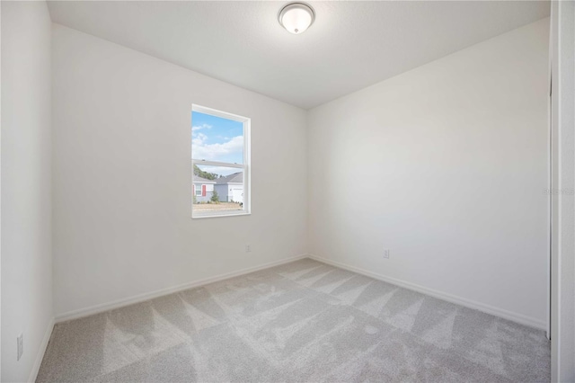 unfurnished room featuring light carpet