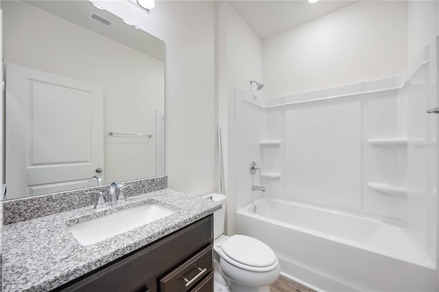 full bathroom featuring vanity, toilet, bathing tub / shower combination, and hardwood / wood-style floors