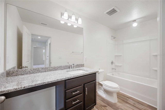 full bathroom with toilet, vanity, bathtub / shower combination, and hardwood / wood-style floors