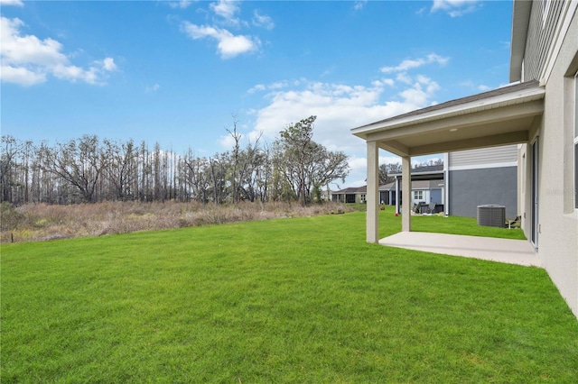 view of yard featuring a patio area and central air condition unit