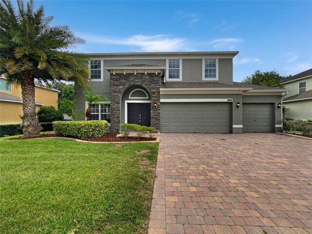 view of front of house featuring a garage and a front lawn