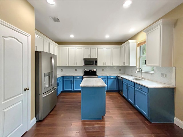 kitchen with a center island, white cabinetry, appliances with stainless steel finishes, blue cabinetry, and sink