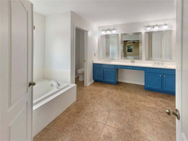 bathroom featuring tile flooring, oversized vanity, dual sinks, and toilet