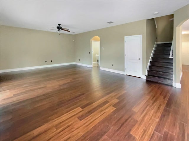 unfurnished living room featuring dark hardwood / wood-style flooring and ceiling fan