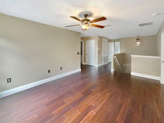 unfurnished living room with dark hardwood / wood-style floors and ceiling fan