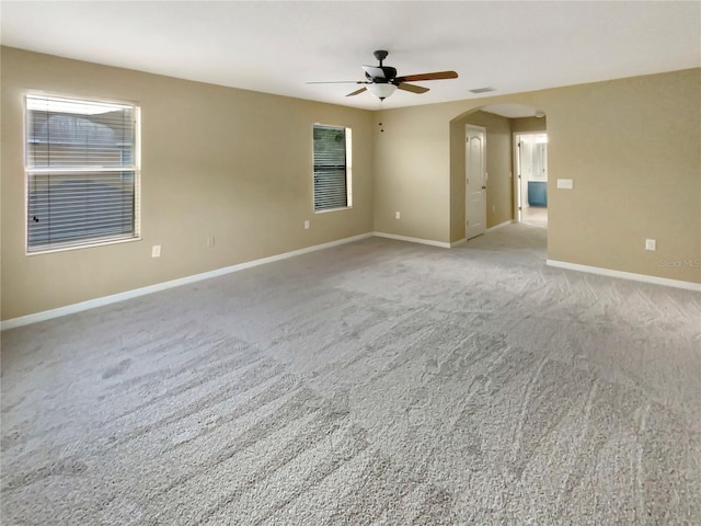 empty room featuring carpet flooring and ceiling fan