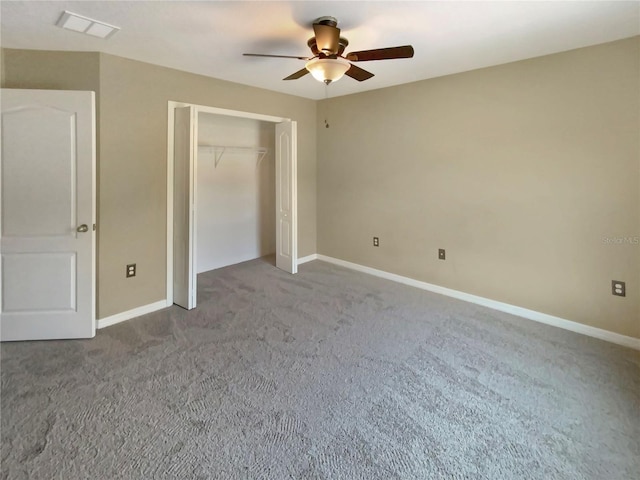 unfurnished bedroom featuring a closet, ceiling fan, and dark carpet