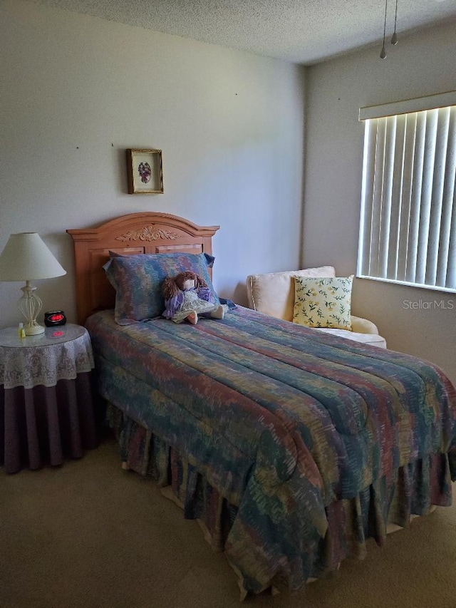 carpeted bedroom featuring a textured ceiling