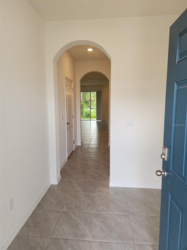 corridor featuring light tile patterned flooring