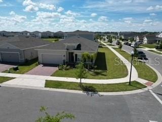 view of front of property featuring a garage and a front lawn