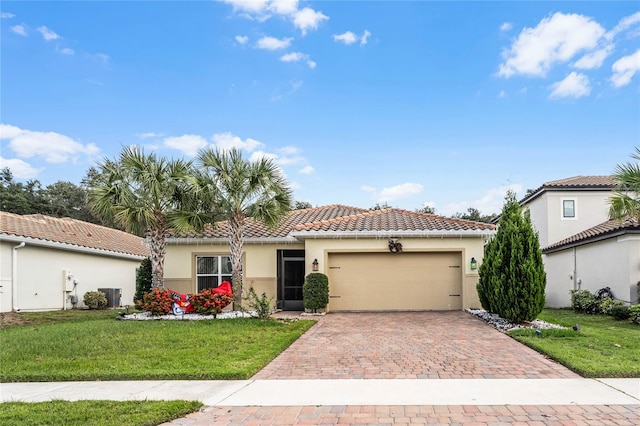 mediterranean / spanish-style house featuring a front yard and a garage