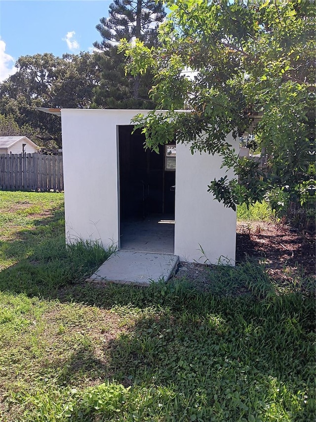 view of outbuilding featuring a yard