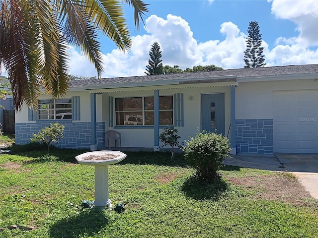 ranch-style home with a garage and a front lawn