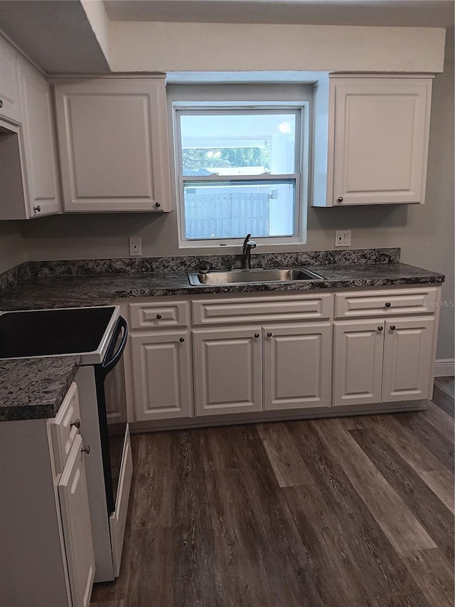 kitchen featuring white cabinetry, dark hardwood / wood-style floors, sink, and range with electric cooktop