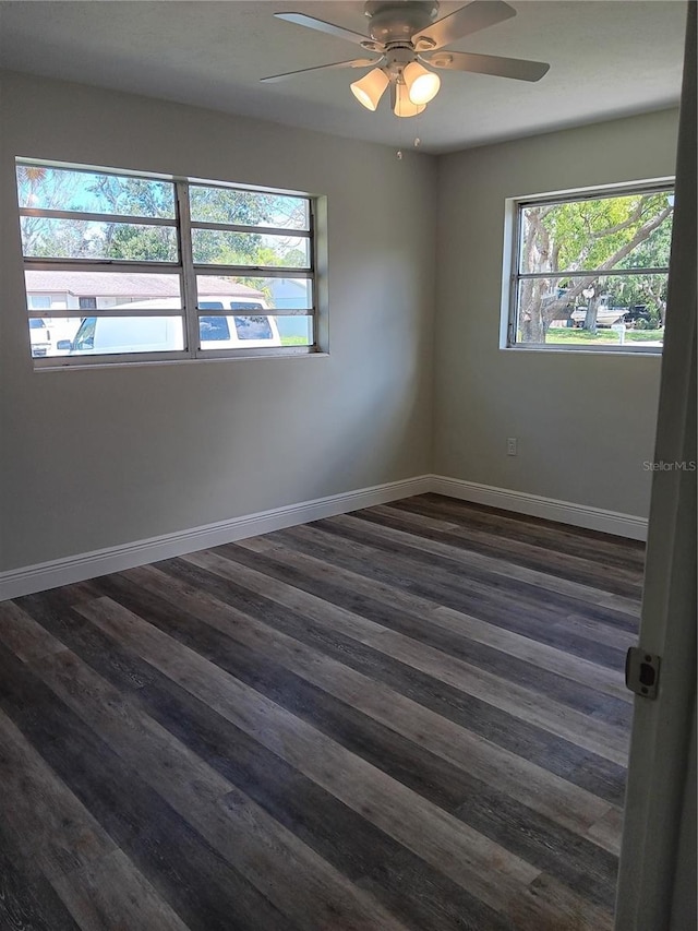 spare room featuring ceiling fan and dark hardwood / wood-style floors