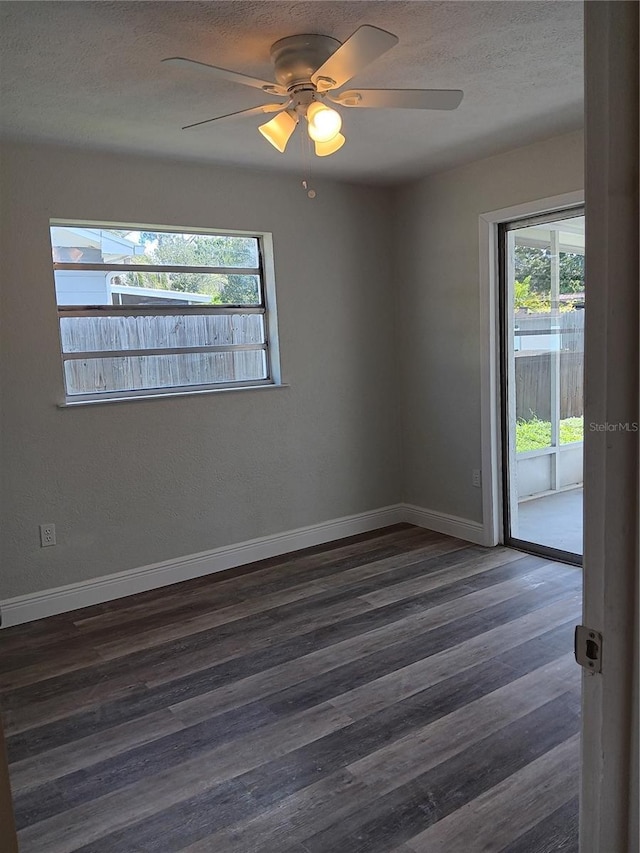 unfurnished room featuring ceiling fan and dark hardwood / wood-style flooring