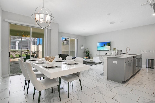 dining room featuring an inviting chandelier and sink