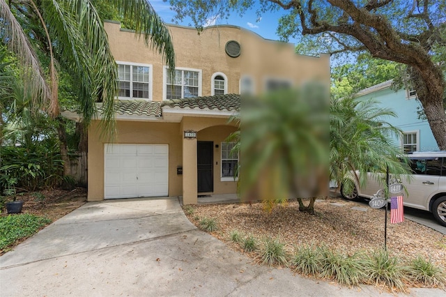 mediterranean / spanish-style home with a garage