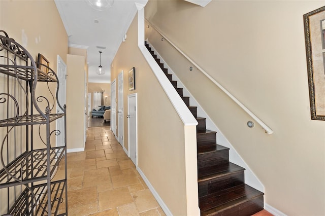 staircase featuring crown molding