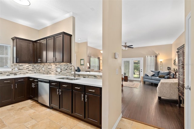 kitchen featuring dark brown cabinetry, decorative backsplash, sink, and stainless steel dishwasher