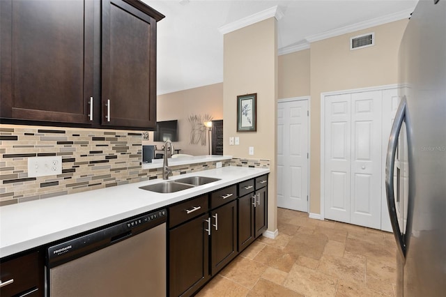 kitchen with sink, tasteful backsplash, crown molding, dark brown cabinets, and appliances with stainless steel finishes