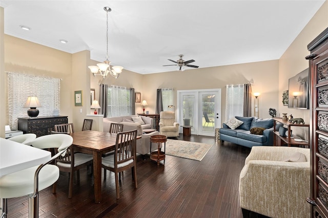 dining space with ceiling fan with notable chandelier, plenty of natural light, and dark wood-type flooring