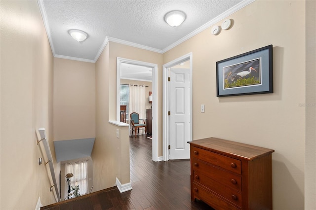 corridor featuring dark hardwood / wood-style floors, ornamental molding, and a textured ceiling