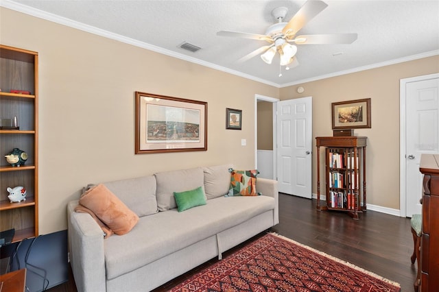 living room featuring a textured ceiling, ceiling fan, crown molding, and dark wood-type flooring