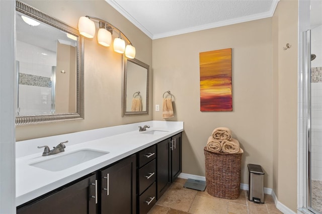 bathroom featuring vanity, an enclosed shower, ornamental molding, and a textured ceiling