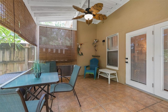 sunroom / solarium featuring lofted ceiling with beams and ceiling fan