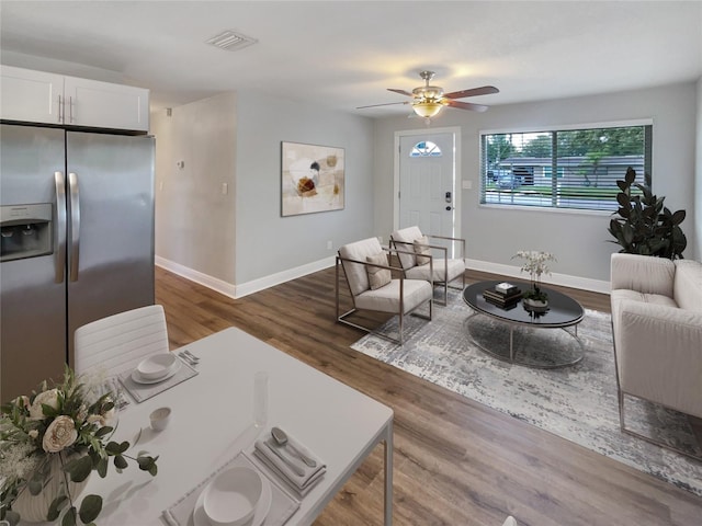 living room with ceiling fan and dark hardwood / wood-style flooring