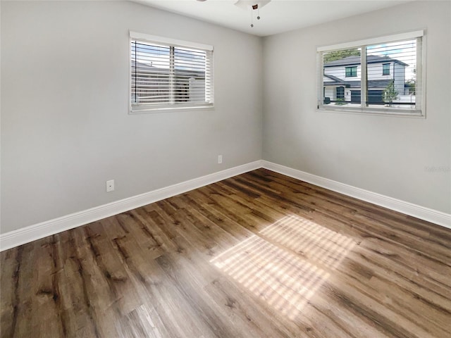 spare room featuring hardwood / wood-style floors, plenty of natural light, and ceiling fan