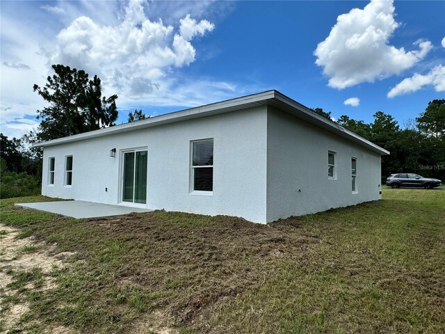 back of property with a patio and a yard