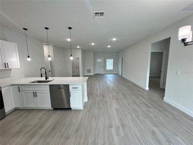 kitchen featuring light hardwood / wood-style floors, white cabinets, pendant lighting, sink, and dishwasher