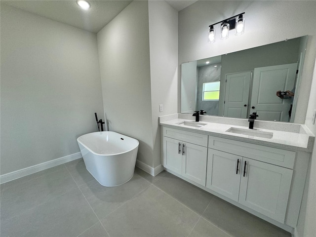 bathroom with a tub, tile flooring, and double vanity