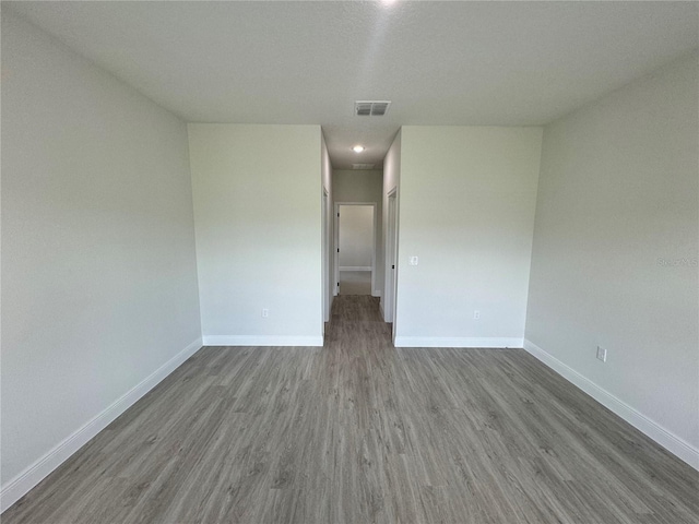 empty room with hardwood / wood-style flooring